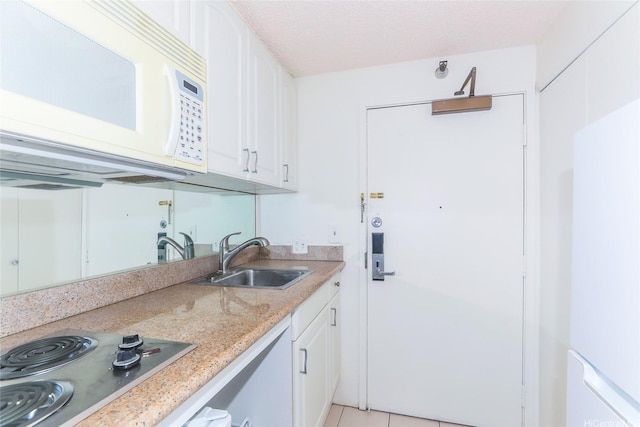 1700 Ala Moana Blvd Unit 603, Honolulu, HI 96815 - kitchen featuring white microwave, stainless steel cooktop, white cabinetry, light tile patterned floors, and light stone counters