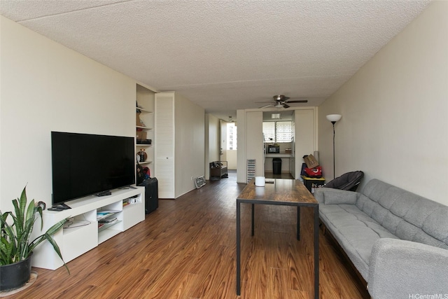 469 Ena Rd Unit 2304, Honolulu, HI 96815 - living room with dark wood-style flooring, a ceiling fan, and a textured ceiling