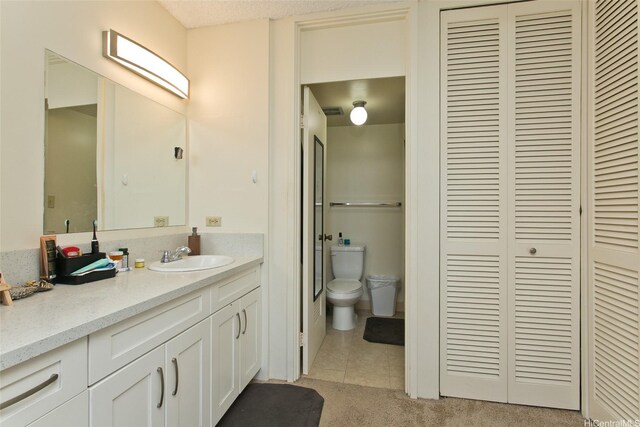 469 Ena Rd Unit 2304, Honolulu, HI 96815 - bathroom featuring a closet, vanity, and tile patterned floors