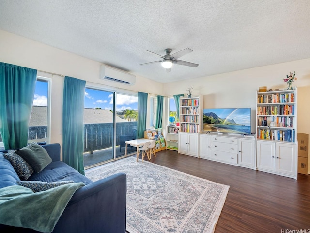 91-265 Hanapouli Cir Unit 16J, Ewa Beach, HI 96706 - living area with a wall unit AC, dark wood-style floors, a textured ceiling, and ceiling fan
