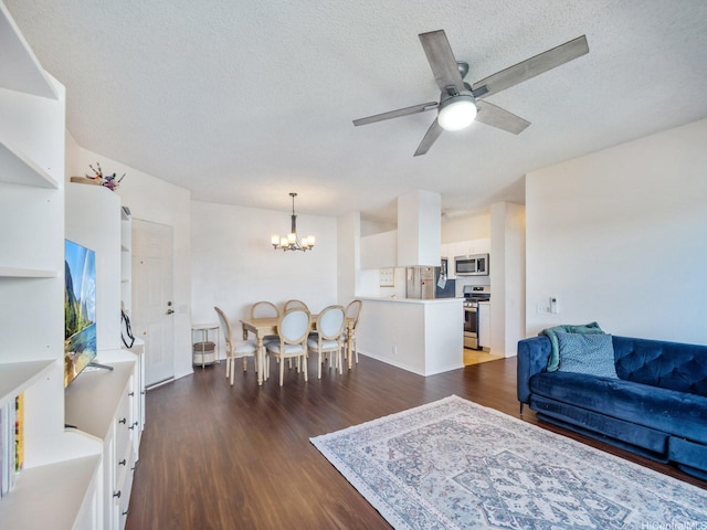 91-265 Hanapouli Cir Unit 16J, Ewa Beach, HI 96706 - living room featuring a chandelier, dark wood-style floors, ceiling fan, and a textured ceiling