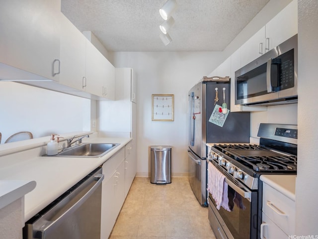 91-265 Hanapouli Cir Unit 16J, Ewa Beach, HI 96706 - kitchen with stainless steel appliances, rail lighting, a textured ceiling, white cabinets, and light countertops