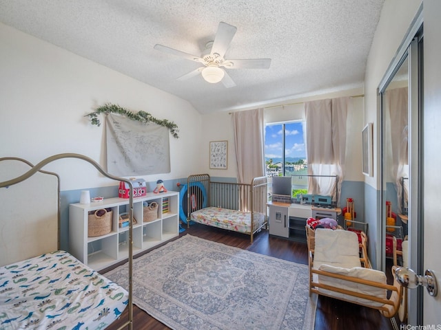 91-265 Hanapouli Cir Unit 16J, Ewa Beach, HI 96706 - bedroom featuring a textured ceiling, wood finished floors, and a ceiling fan