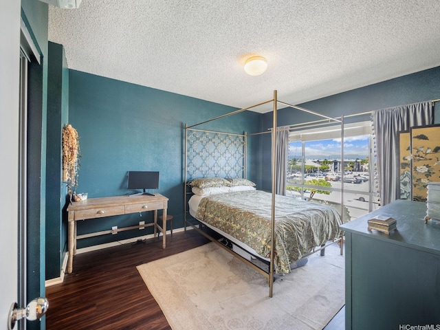 91-265 Hanapouli Cir Unit 16J, Ewa Beach, HI 96706 - bedroom with wood finished floors and a textured ceiling