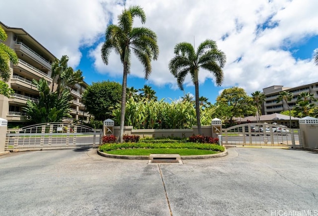 1 Keahole Pl Unit 3512, Honolulu, HI 96825 - view of asphalt road with a gate, a gated entry, and curbs