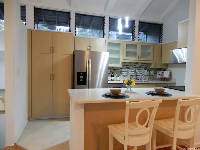 45-995 Wailele Rd Unit 29, Kaneohe, HI 96744 - kitchen with stainless steel refrigerator with ice dispenser, a breakfast bar, light countertops, decorative backsplash, and beamed ceiling