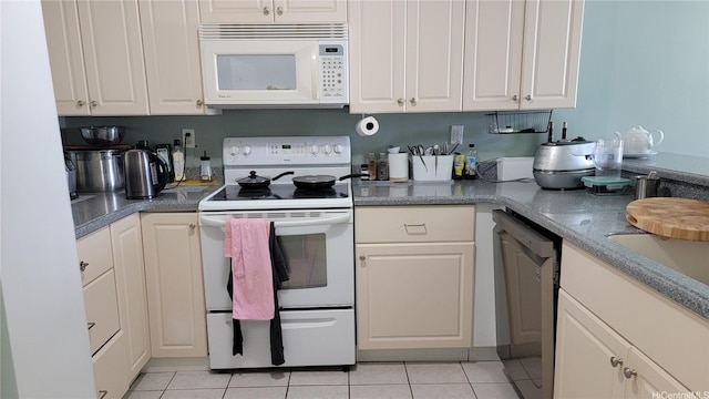 990 Ala Nanala St Unit 22B, Honolulu, HI 96818 - kitchen with white appliances, light tile patterned floors, and white cabinets