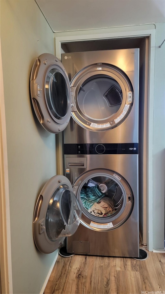 990 Ala Nanala St Unit 22B, Honolulu, HI 96818 - laundry area with stacked washer and clothes dryer and wood finished floors