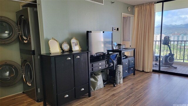 990 Ala Nanala St Unit 22B, Honolulu, HI 96818 - office with stacked washer / dryer, dark wood-type flooring, and a wall of windows
