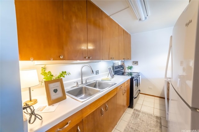 1511 Nuuanu Ave Unit 625, Honolulu, HI 96817 - kitchen featuring electric stove, freestanding refrigerator, light countertops, light tile patterned flooring, and brown cabinets