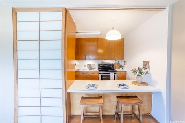 1511 Nuuanu Ave Unit 625, Honolulu, HI 96817 - kitchen featuring stainless steel electric range, brown cabinets, a peninsula, and light countertops