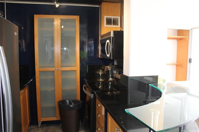 775 Kinalau Pl Unit 2107, Honolulu, HI 96813 - kitchen featuring stainless steel appliances, glass insert cabinets, dark stone counters, and brown cabinets