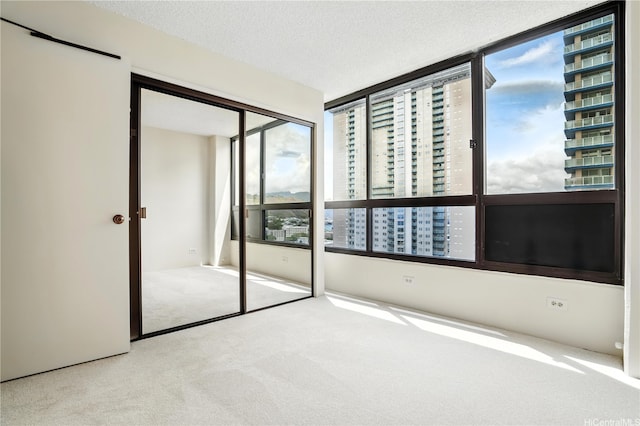 876 Curtis St Unit 3009, Honolulu, HI 96813 - unfurnished bedroom with carpet floors, a closet, and a textured ceiling