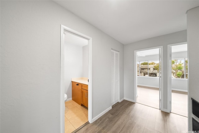 94-557 Alapoai St Unit 154, Mililani, HI 96789 - hallway with light wood-style flooring and baseboards
