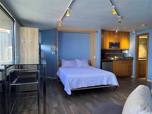 1700 Ala Moana Blvd Unit 2001, Honolulu, HI 96815 - bedroom featuring track lighting and dark wood-style floors