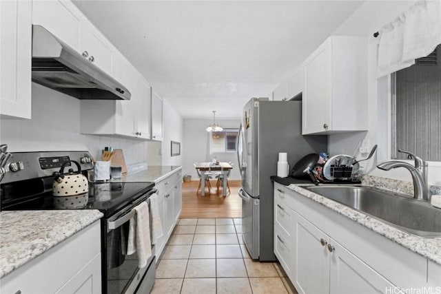 66-924 Kamakahala St, Waialua, HI 96791 - kitchen featuring stainless steel appliances, under cabinet range hood, white cabinets, and light tile patterned flooring