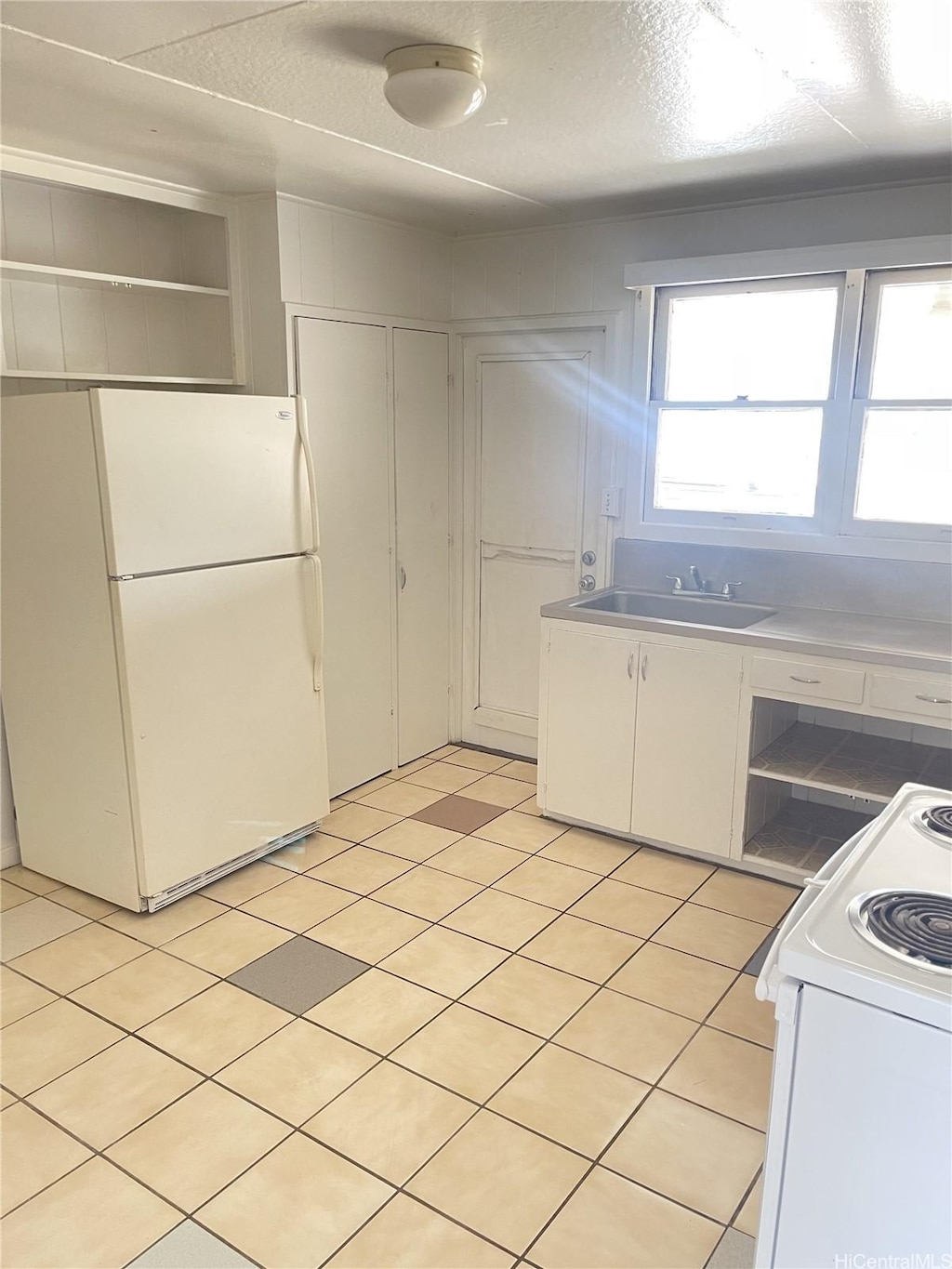 879 3rd St Unit Main, A, B, Pearl City, HI 96782 - kitchen featuring white appliances, open shelves, white cabinets, and a textured ceiling