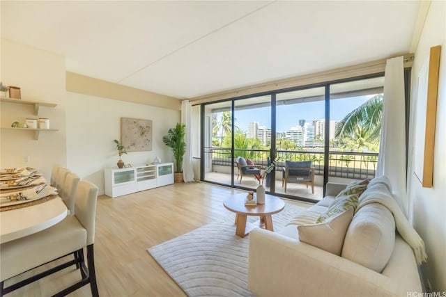 2333 Kapiolani Blvd Unit 311, Honolulu, HI 96826 - living room featuring wood finished floors, a city view, and floor to ceiling windows