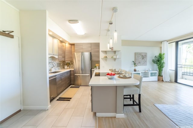 2333 Kapiolani Blvd Unit 311, Honolulu, HI 96826 - kitchen featuring stainless steel appliances, light countertops, a breakfast bar, pendant lighting, and open shelves