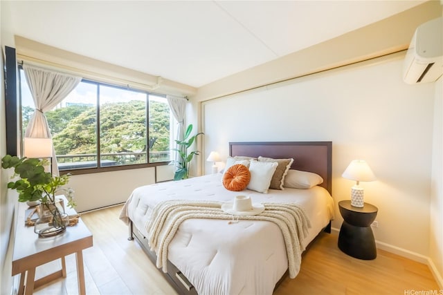 2333 Kapiolani Blvd Unit 311, Honolulu, HI 96826 - bedroom featuring a wall unit AC and light wood-style flooring
