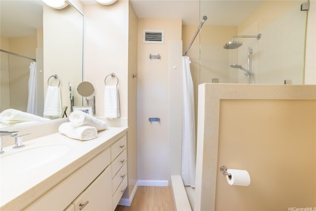 2333 Kapiolani Blvd Unit 311, Honolulu, HI 96826 - bathroom with vanity, a shower with shower curtain, and wood finished floors