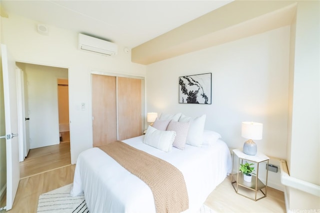 2333 Kapiolani Blvd Unit 311, Honolulu, HI 96826 - bedroom featuring a wall mounted AC, a closet, and light wood-type flooring
