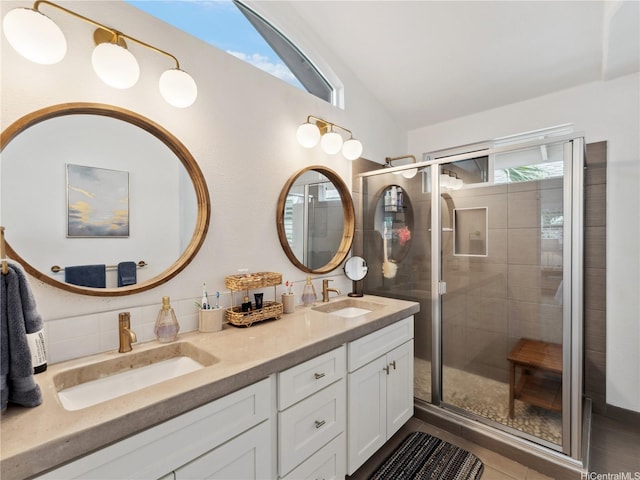 91-1032 Kaikane St, Ewa Beach, HI 96706 - full bathroom featuring double vanity, vaulted ceiling, a stall shower, decorative backsplash, and tile patterned floors