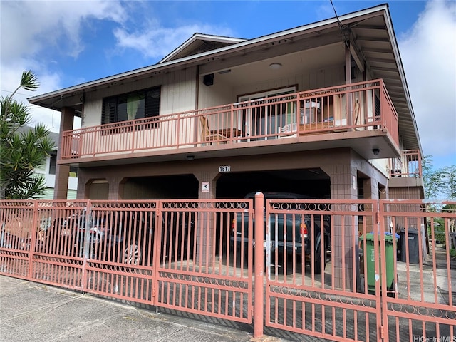 1617 Kamehameha Iv Rd, Honolulu, HI 96819 - view of front facade featuring a balcony, a fenced front yard, and a carport