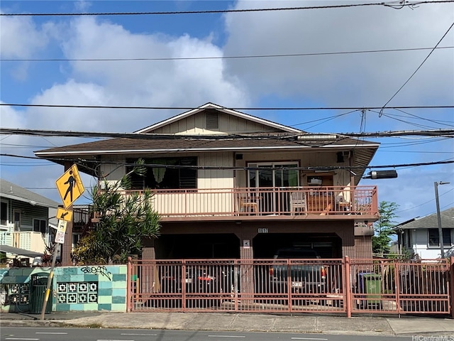 1617 Kamehameha Iv Rd, Honolulu, HI 96819 - view of front facade with a fenced front yard, a balcony, and a shingled roof