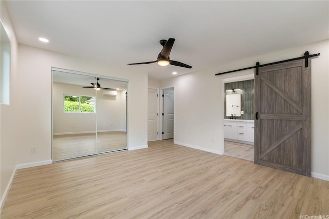 1849 Vancouver Pl, Honolulu, HI 96822 - unfurnished bedroom featuring light wood-type flooring, a barn door, a closet, ensuite bath, and recessed lighting