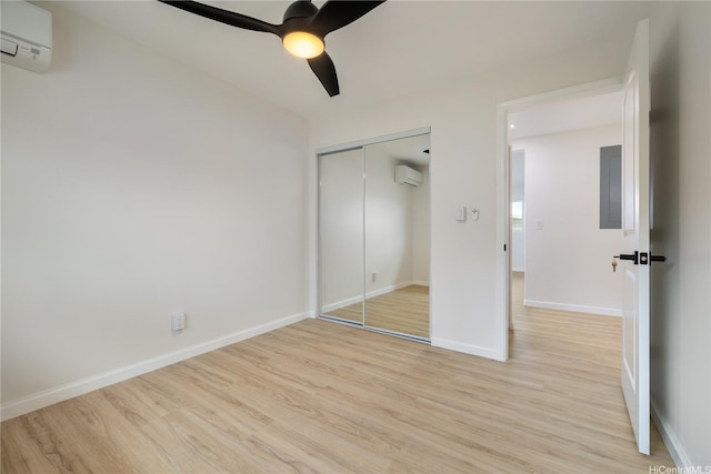 1849 Vancouver Pl, Honolulu, HI 96822 - unfurnished bedroom with a wall mounted AC, light wood-style flooring, a wall unit AC, a closet, and a ceiling fan