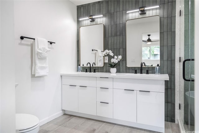 1849 Vancouver Pl, Honolulu, HI 96822 - full bathroom featuring double vanity, a shower stall, ceiling fan, and wood finished floors