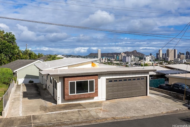 1849 Vancouver Pl, Honolulu, HI 96822 - view of front of home featuring a view of city, an attached garage, and concrete driveway