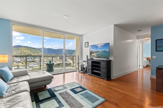 1837 Kalakaua Ave Unit 2209, Honolulu, HI 96815 - living area featuring a wall of windows, wood finished floors, and a textured ceiling