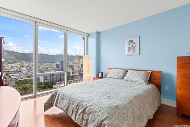 1837 Kalakaua Ave Unit 2209, Honolulu, HI 96815 - bedroom with floor to ceiling windows, wood finished floors, a mountain view, multiple windows, and a view of city