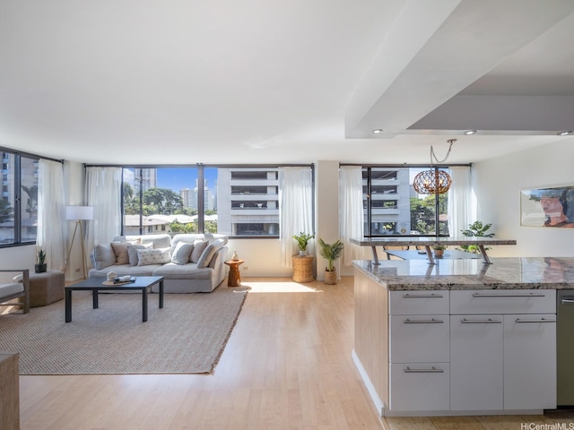 2232 Kapiolani Blvd Unit 303, Honolulu, HI 96826 - living area featuring light wood-style floors and a chandelier