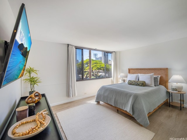 2232 Kapiolani Blvd Unit 303, Honolulu, HI 96826 - bedroom featuring wood finished floors and baseboards