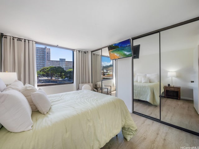 2232 Kapiolani Blvd Unit 303, Honolulu, HI 96826 - bedroom featuring multiple closets and wood finished floors