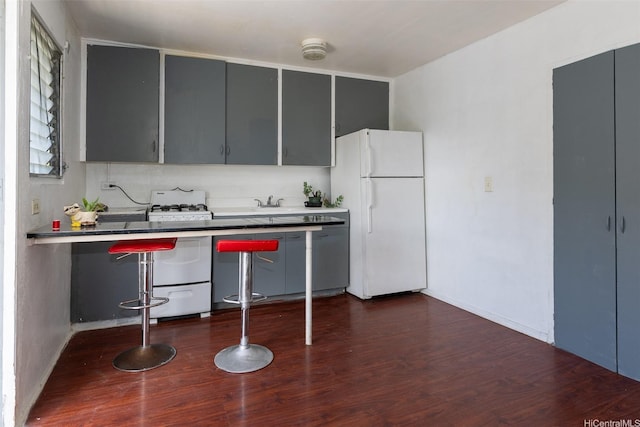 1640 Lusitana St, Honolulu, HI 96813 - kitchen featuring white appliances, dark wood-type flooring, and gray cabinetry