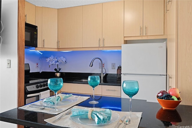 2888 Ala Ilima St Unit 806, Honolulu, HI 96818 - kitchen with freestanding refrigerator, black microwave, stainless steel range with electric cooktop, and light brown cabinets