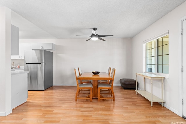 91-1024 Kaiau Ave Unit 4E, Kapolei, HI 96707 - dining room featuring light wood-type flooring, a textured ceiling, and a ceiling fan