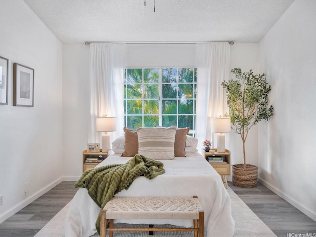 594 Mananai Pl Unit 21T, Honolulu, HI 96818 - bedroom featuring wood finished floors and a textured ceiling