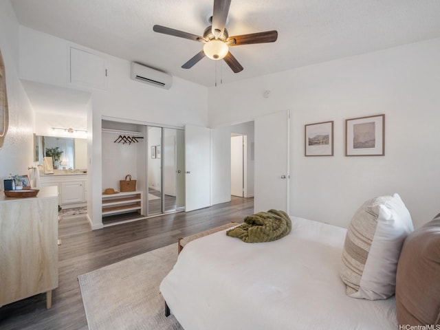 594 Mananai Pl Unit 21T, Honolulu, HI 96818 - bedroom with a wall mounted air conditioner, dark wood-style floors, connected bathroom, a ceiling fan, and a closet