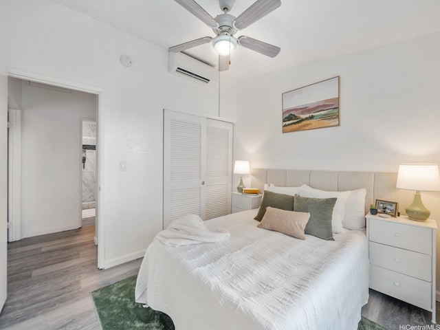 594 Mananai Pl Unit 21T, Honolulu, HI 96818 - bedroom featuring a wall unit AC, wood finished floors, a closet, and a ceiling fan