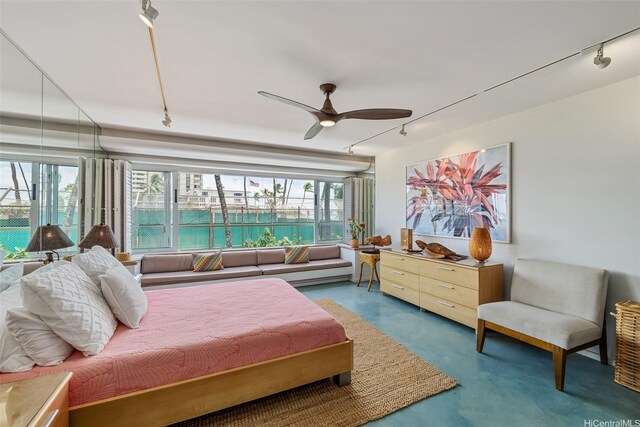 2895 Kalakaua Ave Unit 206, Honolulu, HI 96815 - bedroom with rail lighting, concrete flooring, and ceiling fan