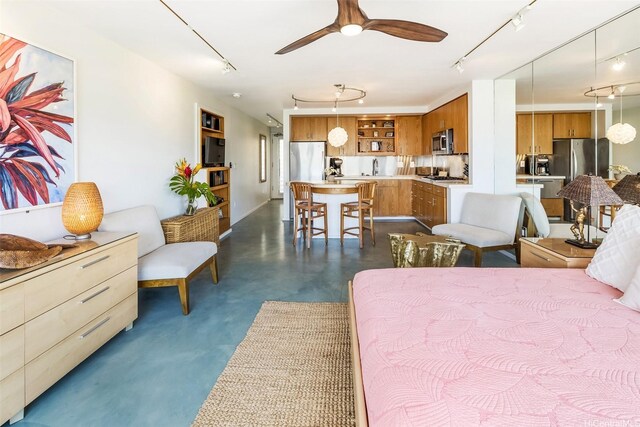 2895 Kalakaua Ave Unit 206, Honolulu, HI 96815 - bedroom with track lighting, freestanding refrigerator, and finished concrete floors