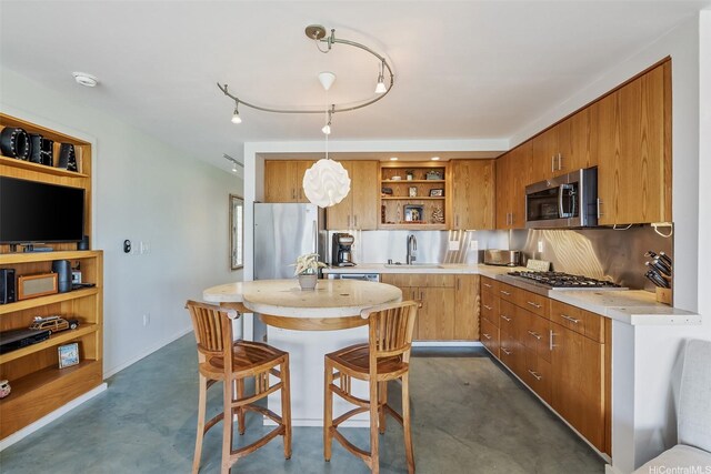 2895 Kalakaua Ave Unit 206, Honolulu, HI 96815 - kitchen featuring appliances with stainless steel finishes, open shelves, light countertops, finished concrete flooring, and brown cabinets