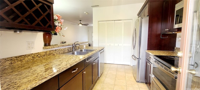 91-6560 Kapolei Pkwy Unit 3G5, Ewa Beach, HI 96706 - kitchen with appliances with stainless steel finishes, a ceiling fan, light stone counters, and light tile patterned flooring