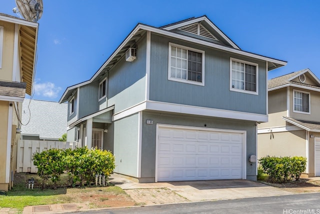 91-1005 Leleoi St Unit 91, Ewa Beach, HI 96706 - view of front facade featuring a garage, a wall mounted air conditioner, and driveway
