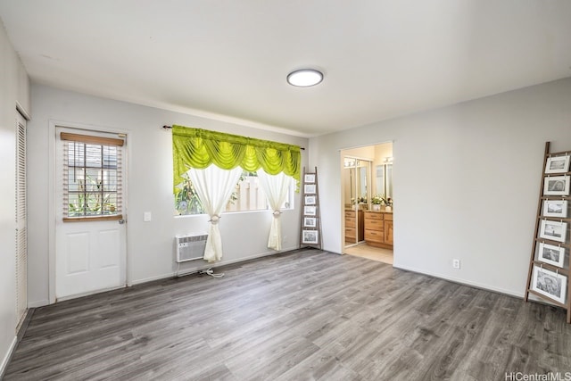 91-1005 Leleoi St Unit 91, Ewa Beach, HI 96706 - unfurnished living room with wood finished floors and an AC wall unit